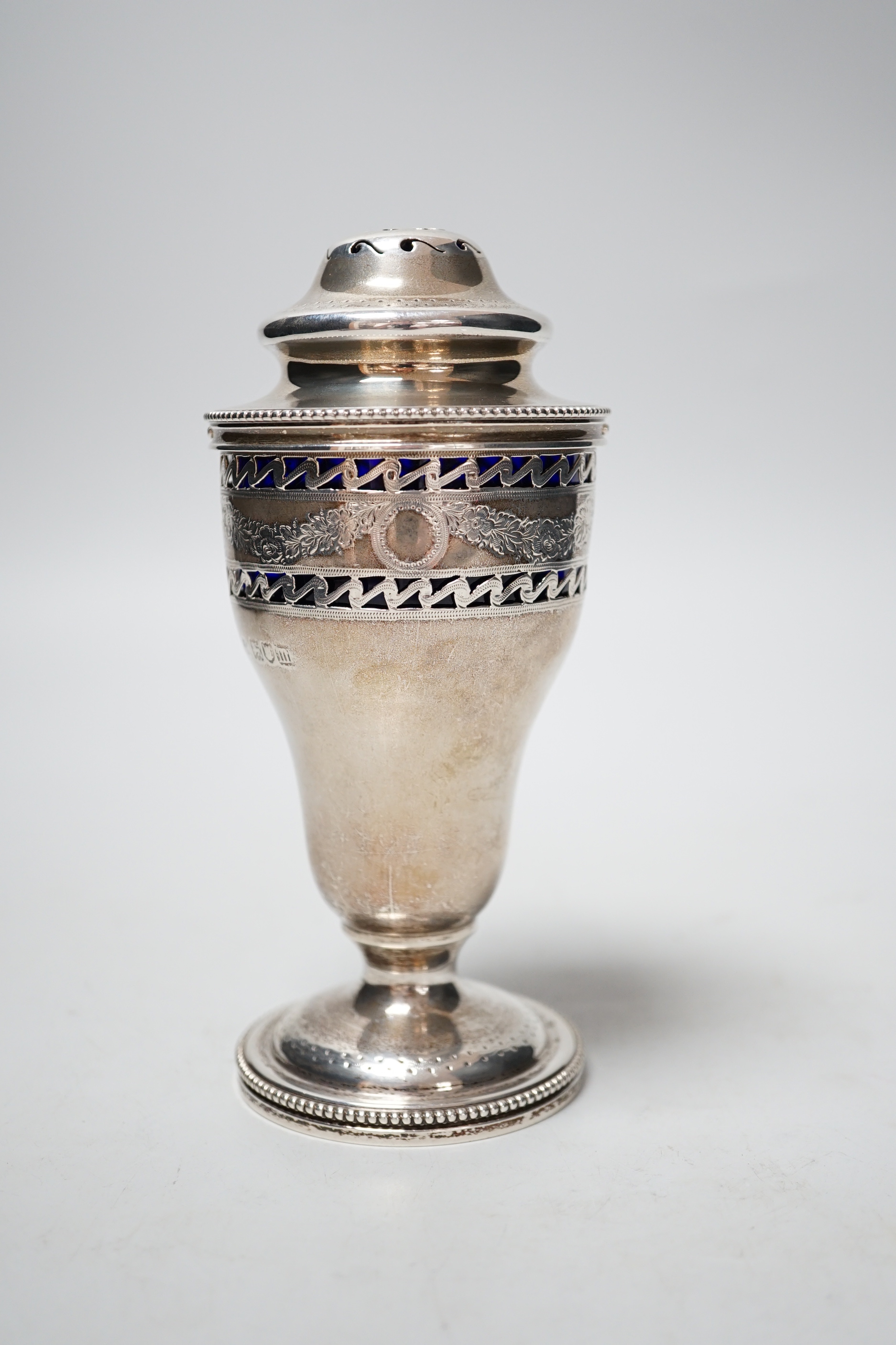 An Edwardian pierced silver sugar sifter, with blue glass liner, Charles Stuart Harris & Sons, London, 1907, 15.2cm.